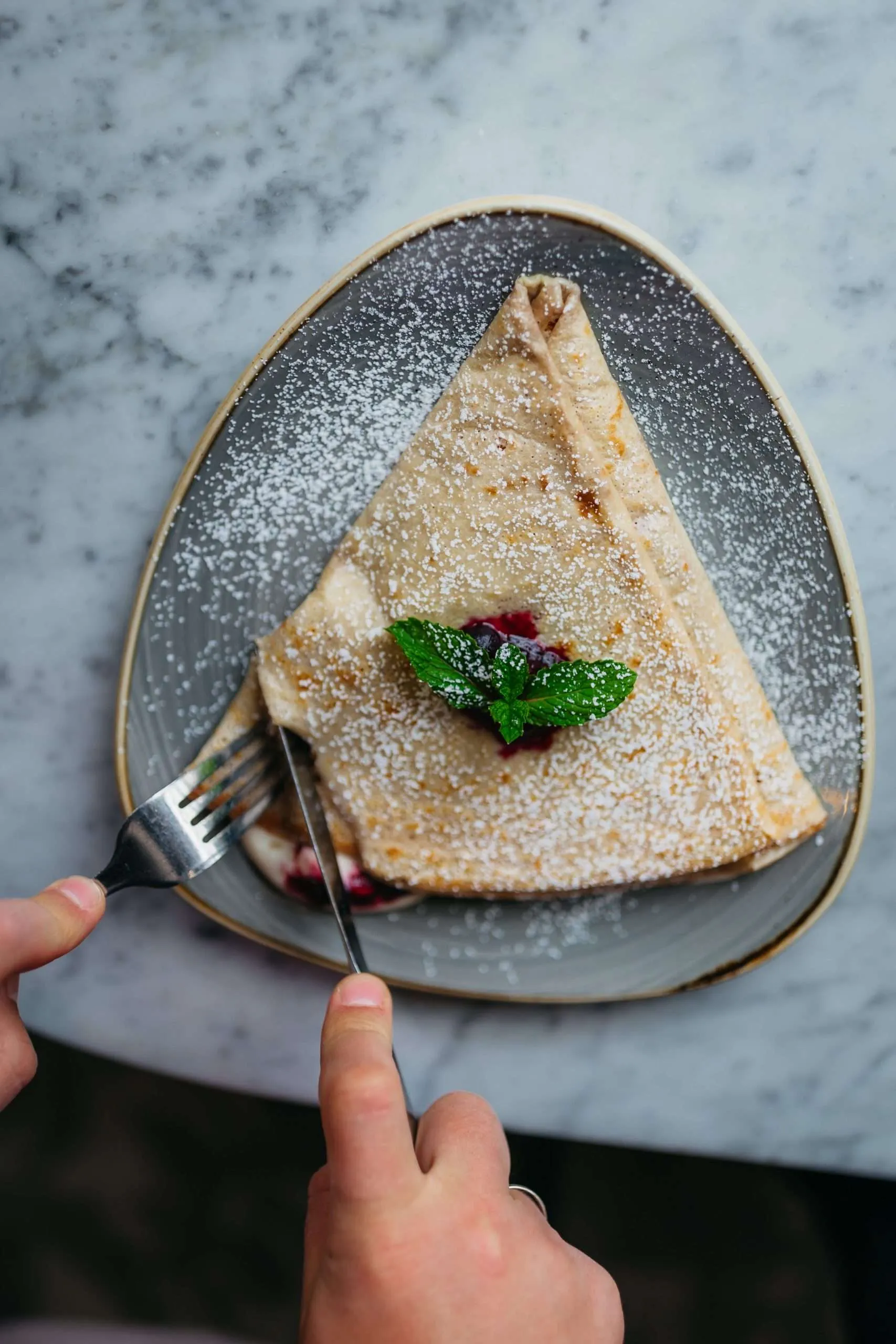 A powdered-sugar crepe served at The Crepe Shop